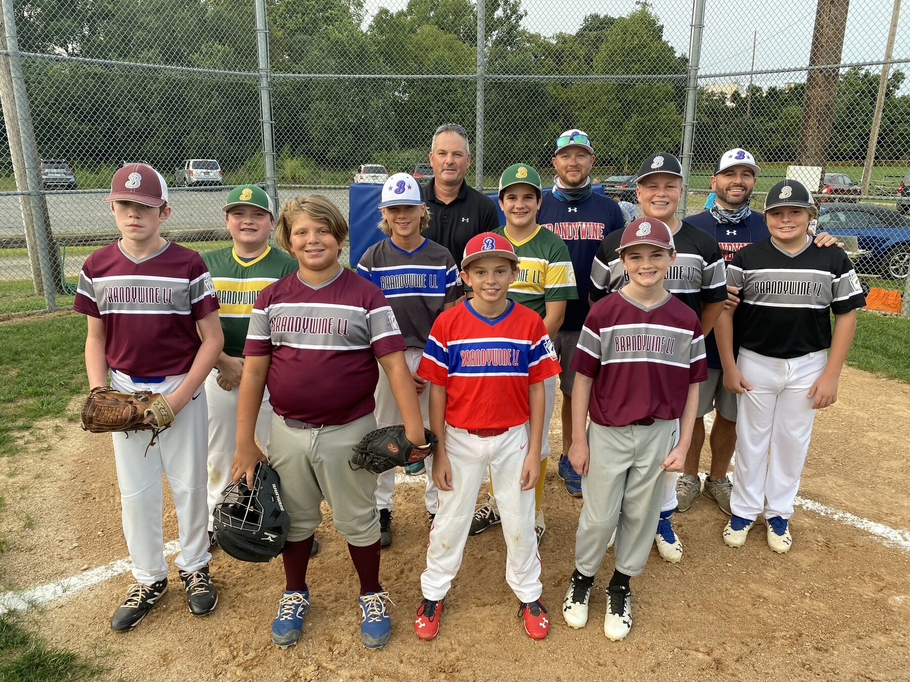 Players and coaches from the 2020 Graduation Game together on the field